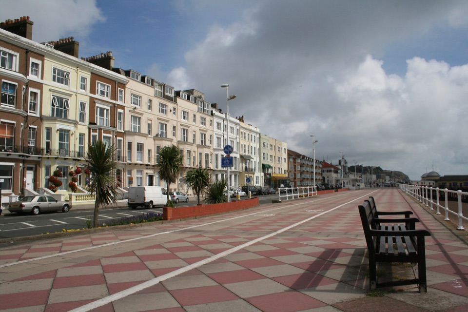 A long seafront terrace of tall houses beside the promenade at Hastings